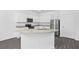Bright kitchen features stainless steel appliances, ample counter space, and a functional island at 567 Bay Leaf Dr, Poinciana, FL 34759