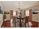 Formal dining room featuring hardwood floors and a large dining table with seating for six at 31817 Sunpark Cir, Leesburg, FL 34748
