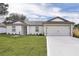 Charming single-story home featuring a two-car garage and a well-manicured lawn at 14945 Sw 38Th Cir, Ocala, FL 34473