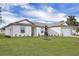 Charming single-story home featuring a two-car garage, well-manicured lawn, and lovely landscaping at 14945 Sw 38Th Cir, Ocala, FL 34473