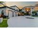 Elegant estate features a circular driveway, manicured landscaping, and an attached three-car garage at 9202 Bay Point Dr, Orlando, FL 32819