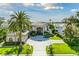 Expansive home showcasing lush landscaping, elegant architecture, and a circular driveway in a waterfront neighborhood at 9202 Bay Point Dr, Orlando, FL 32819