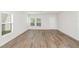 Bright and spacious living room with wood-look floors at 2056 Marigold Aly, Winter Haven, FL 33884