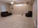 Spacious basement with tile floors, a sofa, and a recliner at 6638 Hatcher Rd, Lakeland, FL 33811