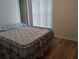 Bedroom with wood-look flooring and window at 6638 Hatcher Rd, Lakeland, FL 33811