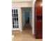 Long hallway with light wood floors and access to other rooms at 6638 Hatcher Rd, Lakeland, FL 33811