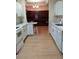 Bright kitchen with light wood floors, white cabinets, and an island at 6638 Hatcher Rd, Lakeland, FL 33811