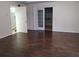 Living room with wood-look flooring and access to other rooms at 6638 Hatcher Rd, Lakeland, FL 33811