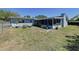 Spacious backyard with a screen porch and a chain-link fence at 1803 Fredricksburg Ave, Lakeland, FL 33803