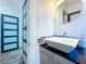 Stylish bathroom featuring a vessel sink, modern fixtures, and a blue accent door at 1803 Fredricksburg Ave, Lakeland, FL 33803