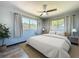 Sunlit bedroom with neutral walls, ceiling fan, and large windows for natural light at 1803 Fredricksburg Ave, Lakeland, FL 33803