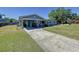 Inviting home exterior featuring a covered carport and lush green lawn at 1803 Fredricksburg Ave, Lakeland, FL 33803