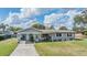 Charming single-story home with a well-maintained lawn and cozy front porch at 1803 Fredricksburg Ave, Lakeland, FL 33803