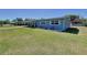 A well-kept home with a lush green lawn and meticulous landscaping at 1803 Fredricksburg Ave, Lakeland, FL 33803