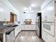 Well-lit kitchen with white cabinets, stainless steel appliances, and a functional layout at 1803 Fredricksburg Ave, Lakeland, FL 33803