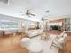 Cozy living room features a brick fireplace, built-in shelving, and two ceiling fans at 1803 Fredricksburg Ave, Lakeland, FL 33803