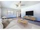 Open-concept living room with wood-look floors, modern furnishings, and a large window at 1803 Fredricksburg Ave, Lakeland, FL 33803