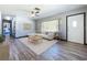 Bright living room with a large window, ceiling fan, and wood-look floors at 1803 Fredricksburg Ave, Lakeland, FL 33803