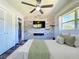 Bright main bedroom with a ceiling fan, wood-look accent wall, and ample closet space at 1803 Fredricksburg Ave, Lakeland, FL 33803