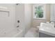 Updated bathroom with subway tile shower and marble floors at 450 Avenue B Ne, Winter Haven, FL 33881