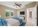 Virtually staged bedroom with a tv and blue bedding at 450 Avenue B Ne, Winter Haven, FL 33881