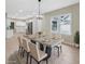 Elegant dining room with a concrete table, neutral chairs, and a modern chandelier at 450 Avenue B Ne, Winter Haven, FL 33881