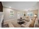 Bright living room with a decorative fireplace, hardwood floors, and a cozy seating area at 450 Avenue B Ne, Winter Haven, FL 33881