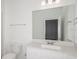 Modern bathroom with white cabinets and a large mirror at 6826 Sw 90Th Loop, Ocala, FL 34476