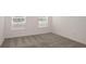 Bright bedroom with neutral carpeting and two windows at 6826 Sw 90Th Loop, Ocala, FL 34476