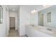 Bright bathroom featuring double sinks, quartz countertop, and a shower with subway tile at 6833 Sw 90Th Loop, Ocala, FL 34476