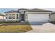 One-story home with gray exterior, two-car garage, and landscaping at 6833 Sw 90Th Loop, Ocala, FL 34476