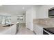Bright kitchen with stainless appliances, modern backsplash, and an open view to the living area at 6833 Sw 90Th Loop, Ocala, FL 34476