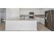 Modern kitchen featuring white cabinets, stainless steel appliances, and a large kitchen island at 6833 Sw 90Th Loop, Ocala, FL 34476