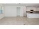 Spacious living area featuring tile flooring, large windows, and an open layout connecting to the kitchen at 6833 Sw 90Th Loop, Ocala, FL 34476