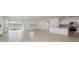 Open-concept living space featuring tile floors, sliding glass doors to the backyard, and a view of the kitchen at 6833 Sw 90Th Loop, Ocala, FL 34476