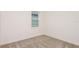 Empty bedroom showcasing neutral carpet and bright natural light at 6837 Sw 90Th Loop, Ocala, FL 34476
