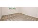 Cozy bedroom with neutral carpet, a window and white walls at 6837 Sw 90Th Loop, Ocala, FL 34476