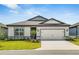 Charming single-story home with a well-manicured lawn, two-car garage and neutral color scheme at 6837 Sw 90Th Loop, Ocala, FL 34476