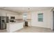 Spacious kitchen with stainless steel appliances, white cabinetry, and a central island open to the dining area at 6837 Sw 90Th Loop, Ocala, FL 34476