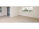 Spacious room featuring tile flooring, ample natural light, and a sliding glass door closet at 6837 Sw 90Th Loop, Ocala, FL 34476