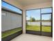 Screened patio looking out to the yard with grass at 6837 Sw 90Th Loop, Ocala, FL 34476