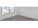 Simple bedroom with gray carpet and a window at 6829 Sw 90Th Loop, Ocala, FL 34476