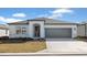 One-story home with gray garage door and landscaping at 6829 Sw 90Th Loop, Ocala, FL 34476
