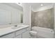 Bathroom with white vanity and tiled shower/tub combo at 419 Pine Tree Blvd, Lake Alfred, FL 33850