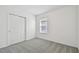 Spacious bedroom with grey carpet, neutral walls and double-door closet at 419 Pine Tree Blvd, Lake Alfred, FL 33850