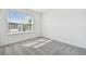 Bedroom with grey carpet and window with blinds at 419 Pine Tree Blvd, Lake Alfred, FL 33850