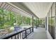 Covered back porch featuring wood floors and railings, with a view of the landscaped backyard at 3603 Cr 626N, Bushnell, FL 33513