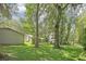 Expansive backyard featuring a shed, a carport, lush greenery, and a well-manicured lawn at 3603 Cr 626N, Bushnell, FL 33513
