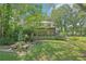 Exterior shot showcasing the backyard with a sunroom, table and chairs at 3603 Cr 626N, Bushnell, FL 33513
