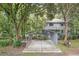 Exterior shot of home featuring a carport, mature trees and landscaping around the property at 3603 Cr 626N, Bushnell, FL 33513